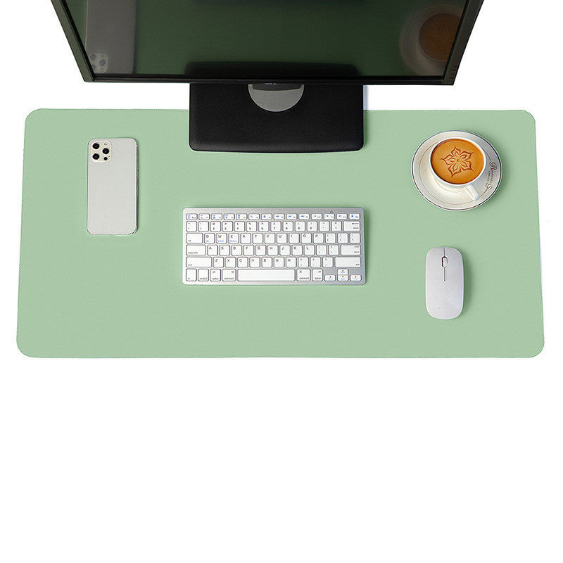 Green desk mat and mouse pad displayed with a monitor, keyboard, and mouse, perfect for a minimal modern workspace.