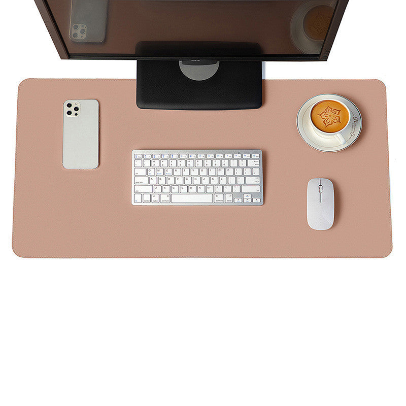 Nude desk mat and mouse pad styled in a feminine, chic workspace with tech accessories and a warm coffee.