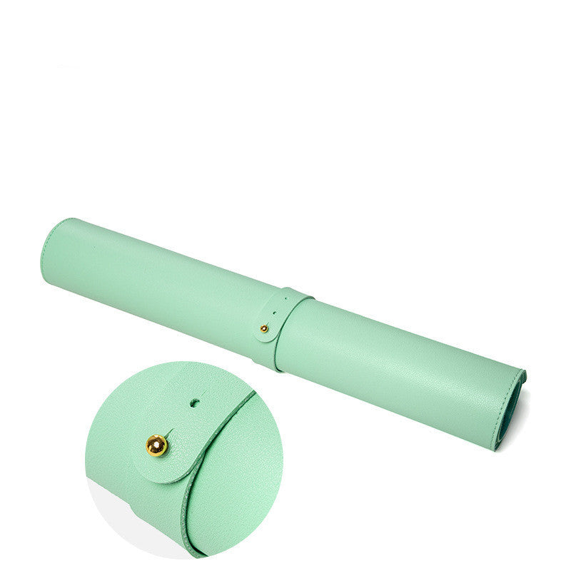 Green desk mat and mouse pad displayed rolled up with a fastener for easy storage.