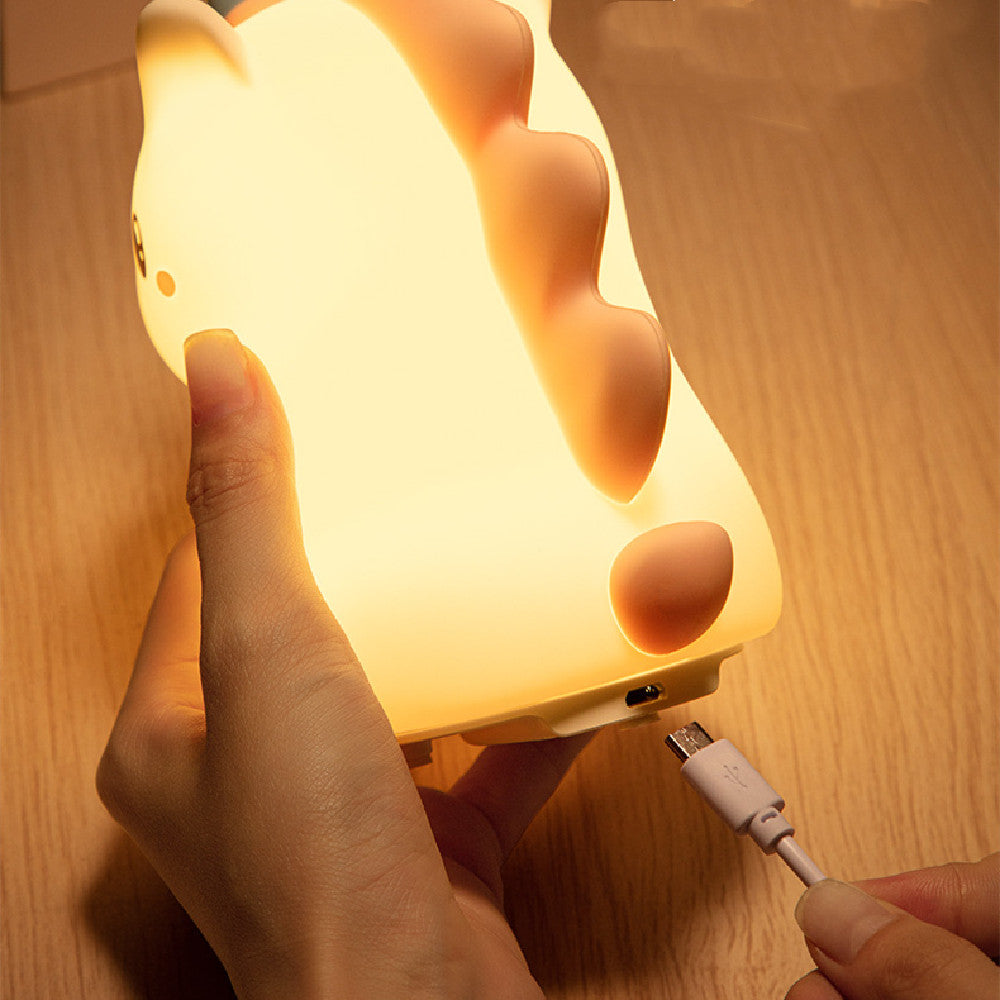 Close-up of unicorn night light being charged with a USB cable, showing the convenient power port at the base.