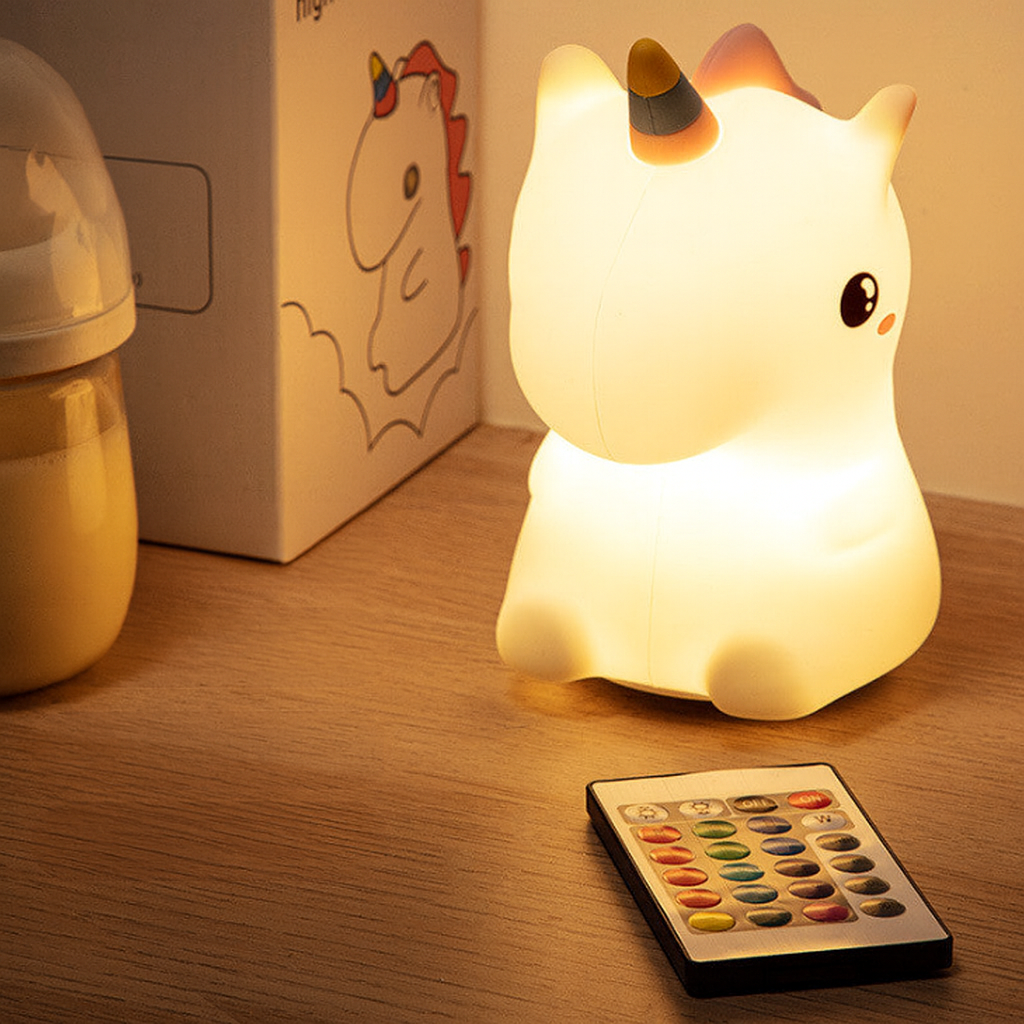 Unicorn night light with remote control, glowing softly on a bedside table, ideal for baby nursery or children's bedroom.