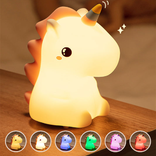 Soft silicone LED unicorn night light glowing on a bedside table with colour-changing options shown below. Perfect for nurseries, kids’ rooms, and calming night-time routines.